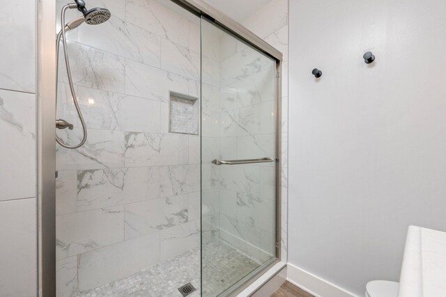 bathroom with a shower with door