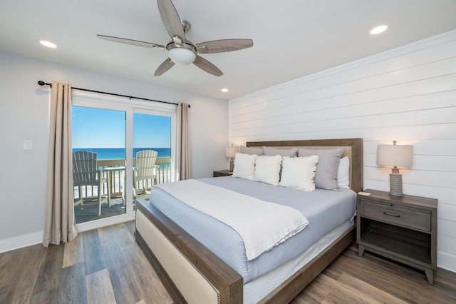 bedroom featuring access to exterior, ceiling fan, a water view, and hardwood / wood-style floors