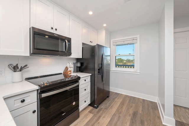 kitchen with white cabinetry, backsplash, and appliances with stainless steel finishes