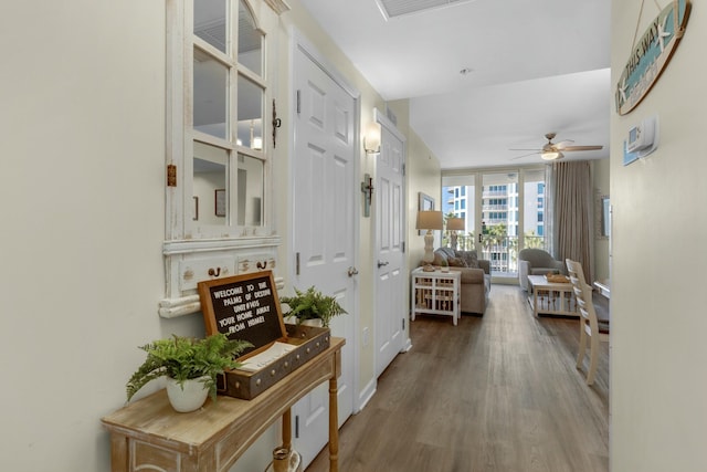 hallway featuring expansive windows and wood-type flooring