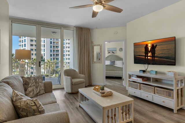 living room featuring light hardwood / wood-style floors and ceiling fan