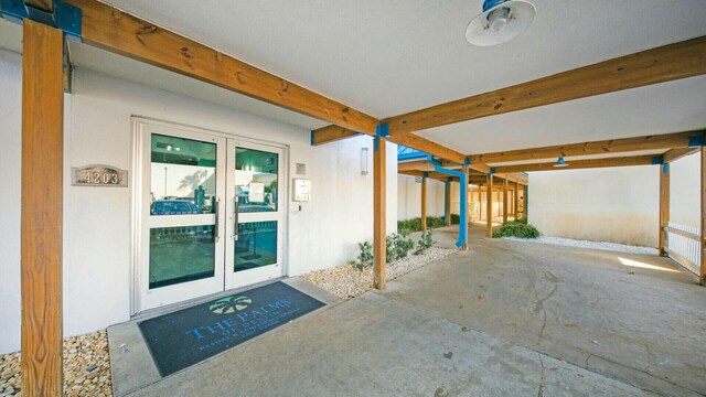 entrance to property with a patio area and french doors