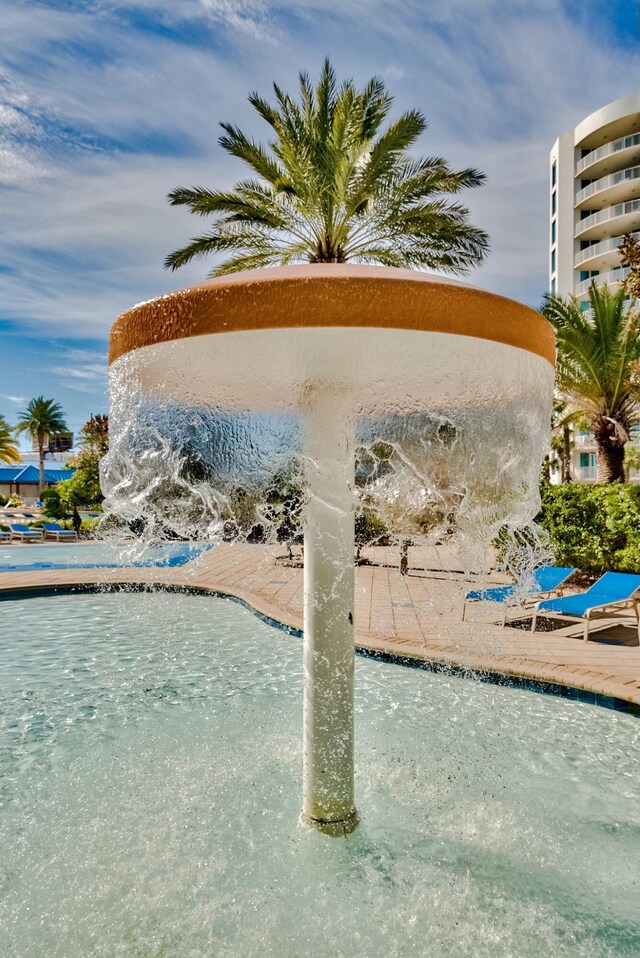 view of swimming pool featuring pool water feature