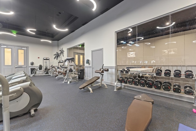 exercise room with a raised ceiling