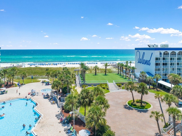 drone / aerial view featuring a water view and a view of the beach