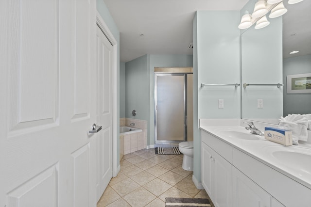 full bathroom with tile patterned floors, vanity, independent shower and bath, and toilet