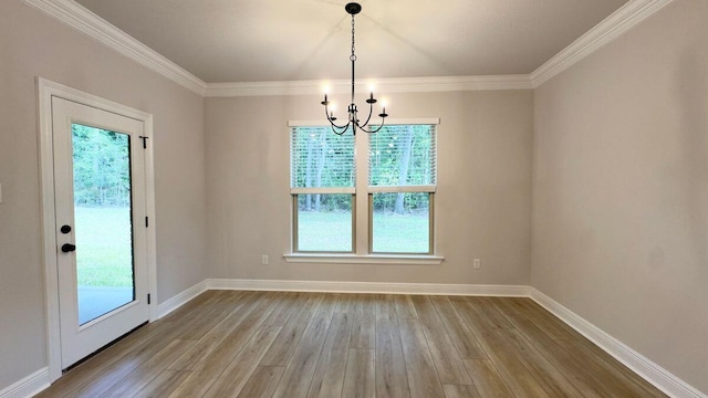 2718 Louis Cir, Crestview, FL 32536 - unfurnished dining area featuring a chandelier, crown molding, baseboards, and wood finished floors