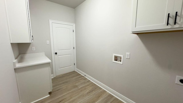 2718 Louis Cir, Crestview, FL 32536 - laundry area featuring baseboards, washer hookup, light wood-style floors, hookup for an electric dryer, and cabinet space