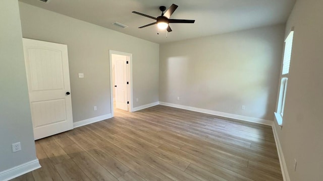 2718 Louis Cir, Crestview, FL 32536 - unfurnished bedroom featuring baseboards, a ceiling fan, visible vents, and wood finished floors