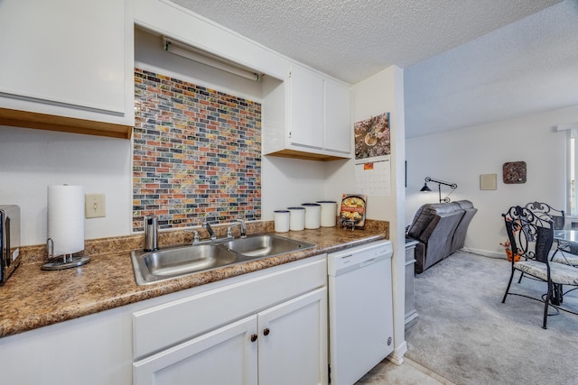 kitchen featuring light carpet, a textured ceiling, sink, dishwasher, and white cabinetry