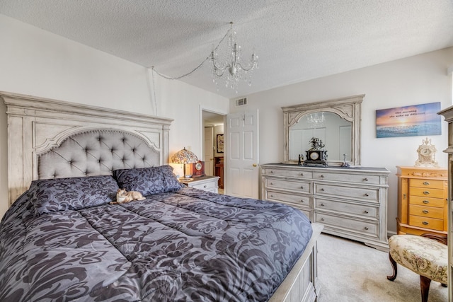 bedroom featuring a textured ceiling and light colored carpet