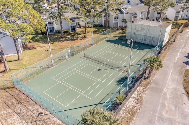 view of sport court with a yard