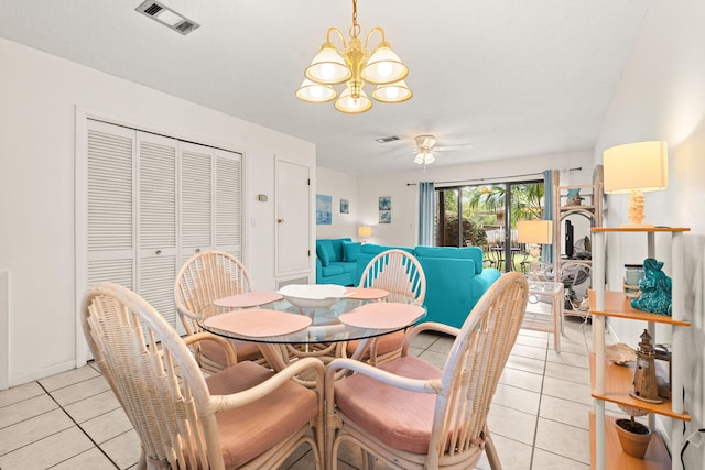 tiled dining space featuring ceiling fan with notable chandelier