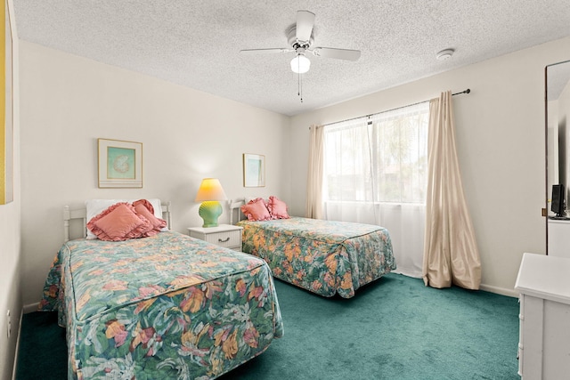 bedroom with carpet, ceiling fan, and a textured ceiling