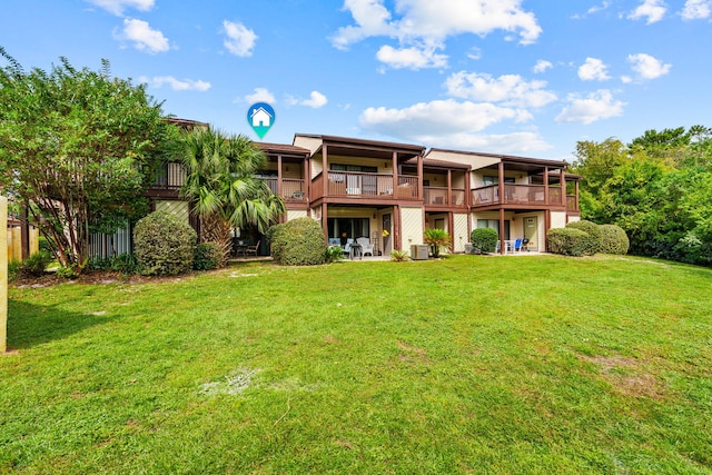 rear view of property featuring a lawn