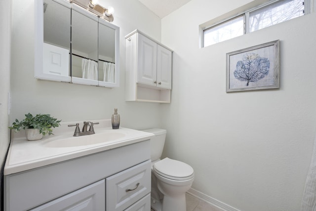 bathroom featuring vanity, tile patterned floors, and toilet