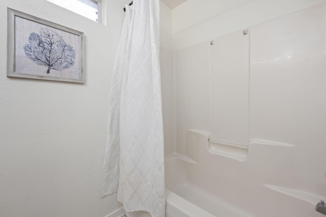 bathroom with shower / bathtub combination with curtain