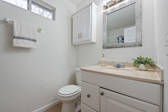 bathroom featuring tile patterned floors, vanity, and toilet