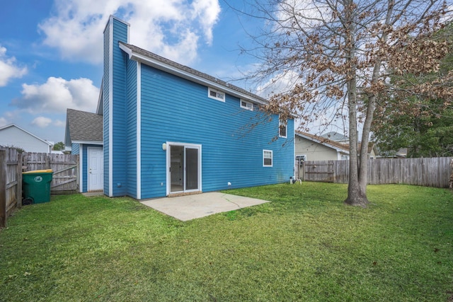 rear view of house with a yard and a patio