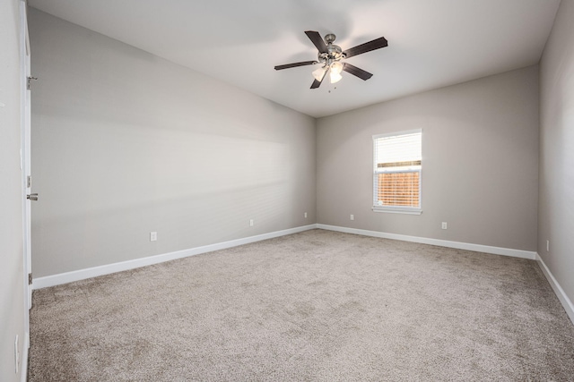 empty room featuring ceiling fan and carpet