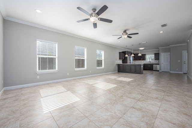 unfurnished living room with plenty of natural light, ceiling fan, sink, and crown molding