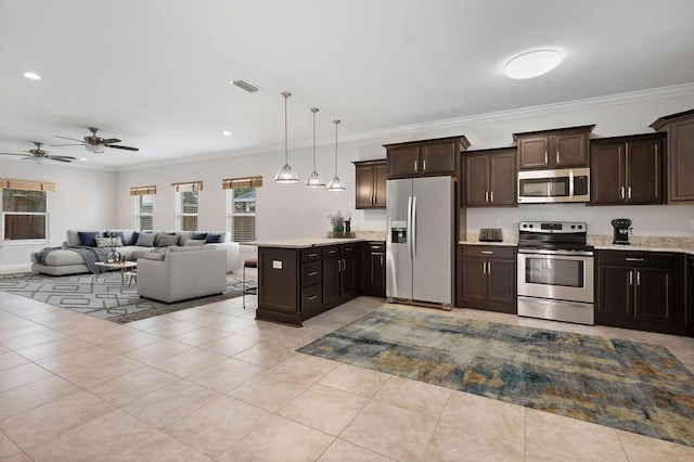 kitchen featuring ceiling fan, crown molding, pendant lighting, dark brown cabinets, and appliances with stainless steel finishes