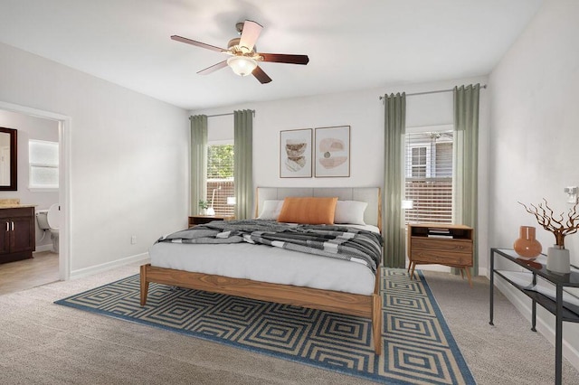 carpeted bedroom featuring ensuite bathroom and ceiling fan