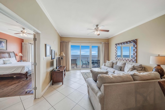 living room featuring crown molding, light tile patterned flooring, and ceiling fan