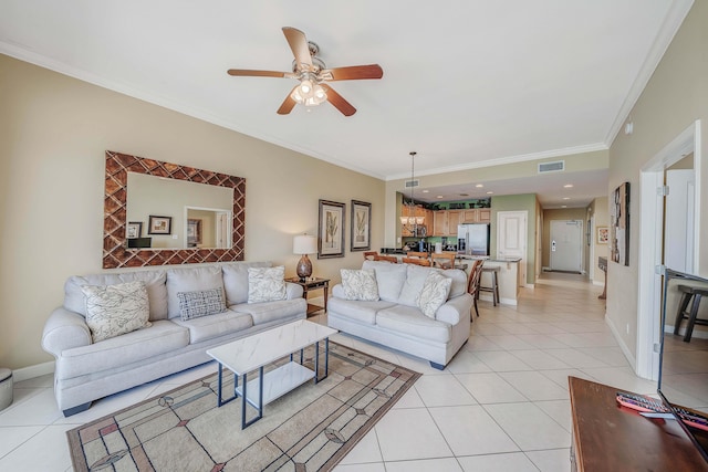 tiled living room featuring crown molding and ceiling fan