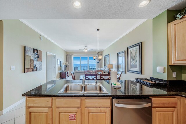 kitchen featuring dishwasher, light tile patterned flooring, crown molding, and sink