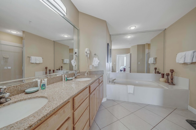 bathroom featuring tile patterned floors, vanity, and shower with separate bathtub