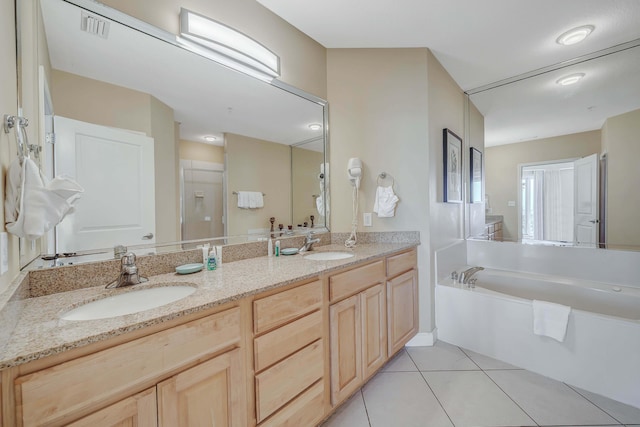 bathroom with plus walk in shower, vanity, and tile patterned floors