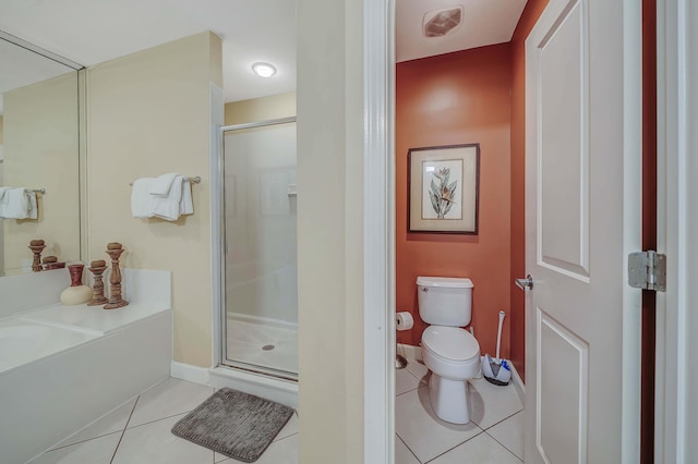 bathroom featuring plus walk in shower, tile patterned flooring, and toilet