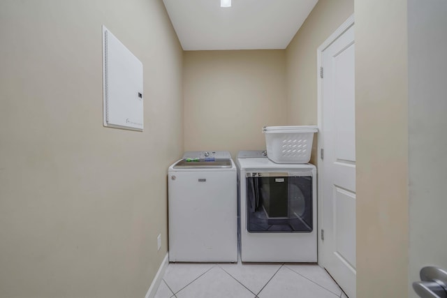 laundry room with washer and dryer and light tile patterned flooring