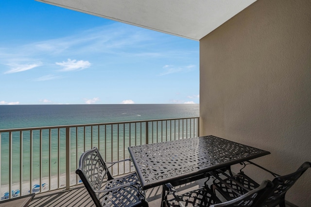 balcony with a water view and a beach view