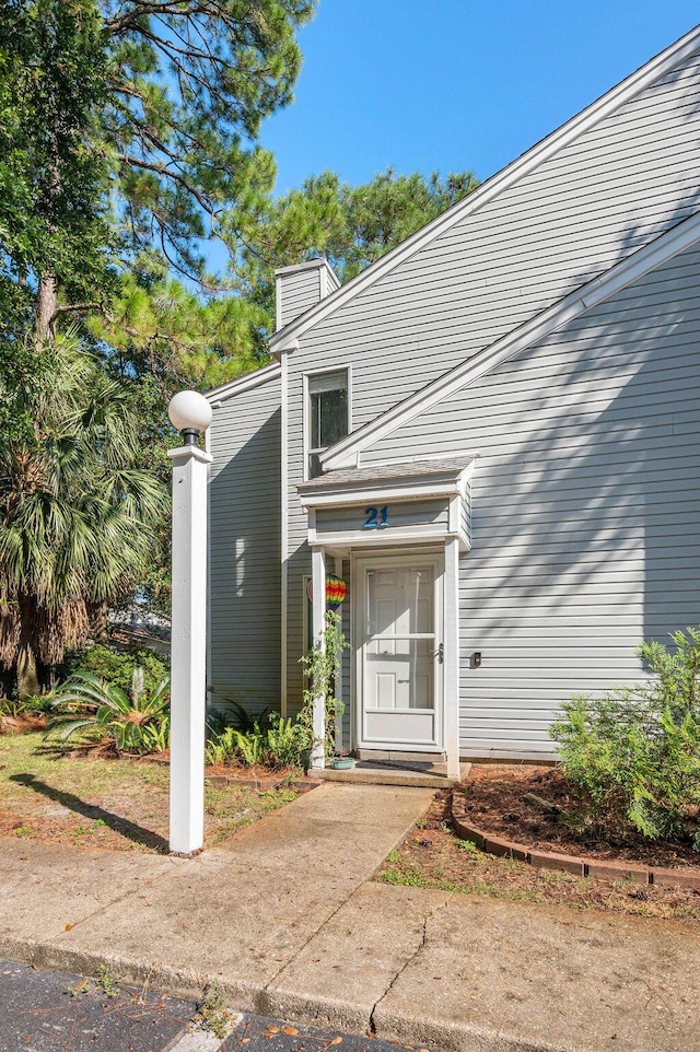 property entrance with a chimney