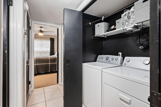 laundry area with laundry area, separate washer and dryer, and light tile patterned flooring