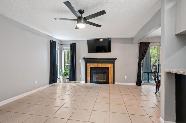 unfurnished living room with a healthy amount of sunlight, light tile patterned flooring, and a tile fireplace