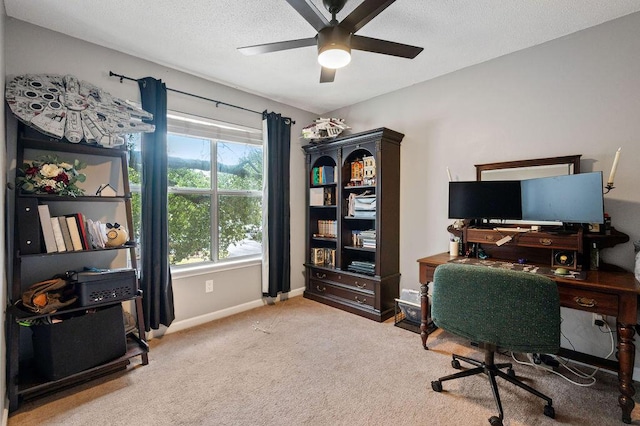 office space featuring ceiling fan, a textured ceiling, carpet flooring, and baseboards