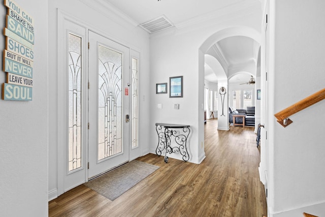 entrance foyer featuring ceiling fan, hardwood / wood-style floors, and ornamental molding