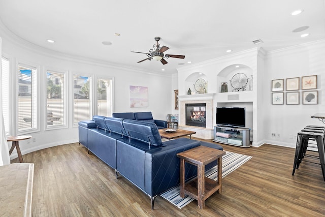 living room with hardwood / wood-style floors, ceiling fan, and ornamental molding