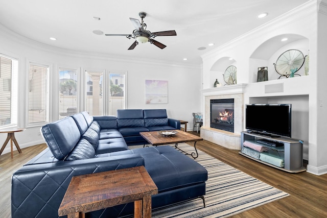 living room with crown molding, ceiling fan, and hardwood / wood-style flooring