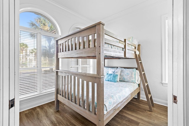 bedroom with dark hardwood / wood-style flooring and crown molding