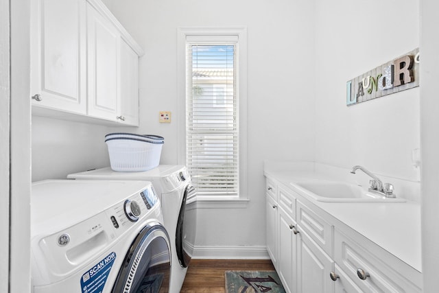 laundry room featuring cabinets, independent washer and dryer, sink, and dark wood-type flooring