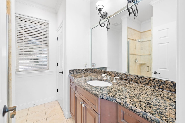 bathroom with tile patterned flooring, vanity, walk in shower, and ornamental molding