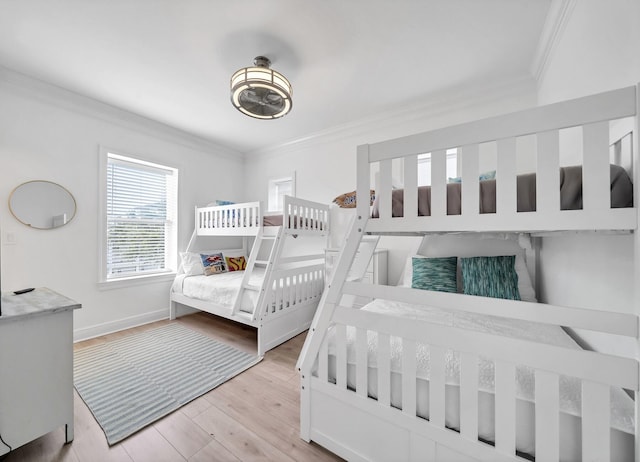 bedroom featuring light hardwood / wood-style flooring and crown molding