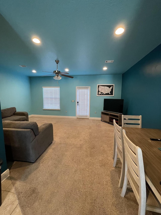 living room with light colored carpet and ceiling fan