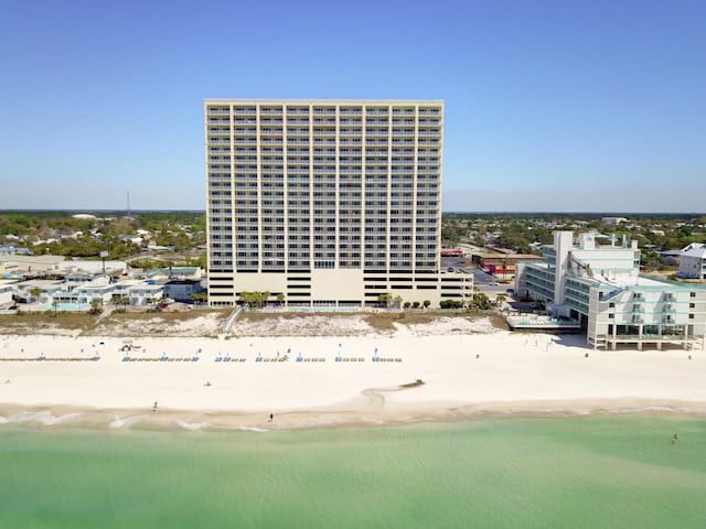 view of property with a beach view and a water view