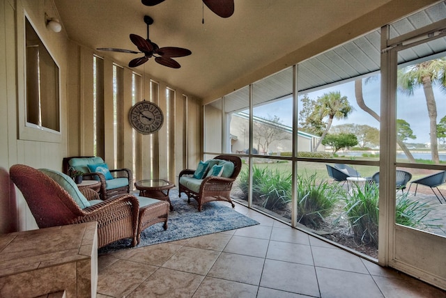 sunroom with plenty of natural light, lofted ceiling, and ceiling fan