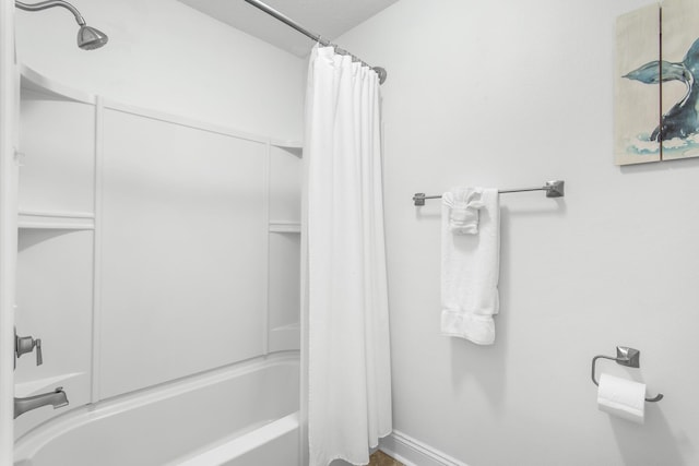 bathroom with shower / bathtub combination with curtain